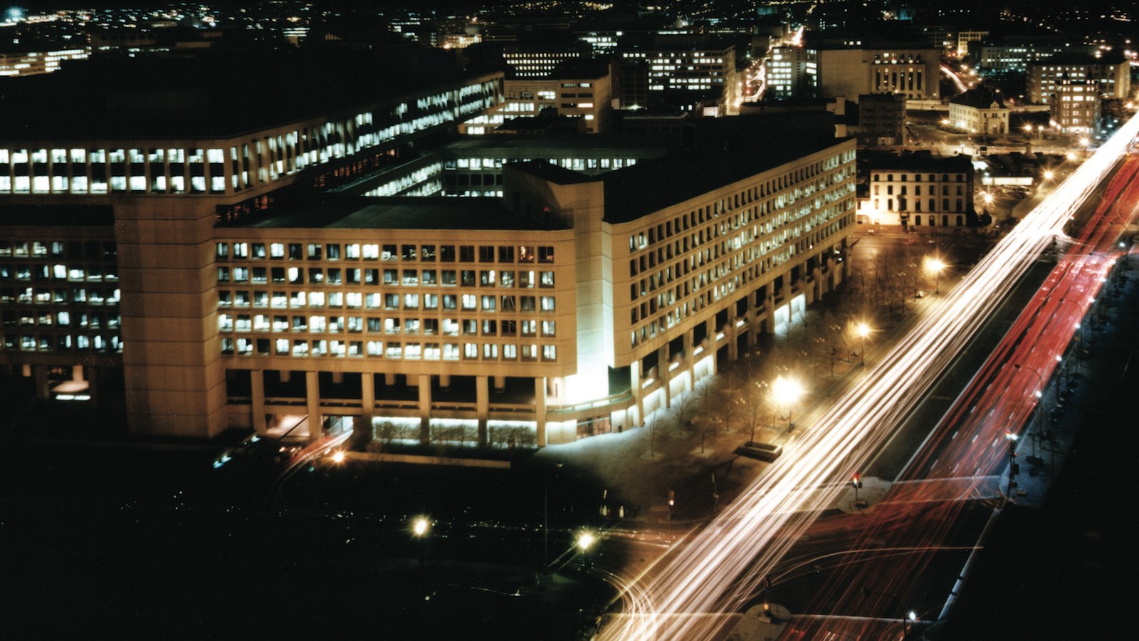 J. Edgar Hoover Building (FBI HQ) at night — Arctic Frost / DOJ-FBI dragnet motif